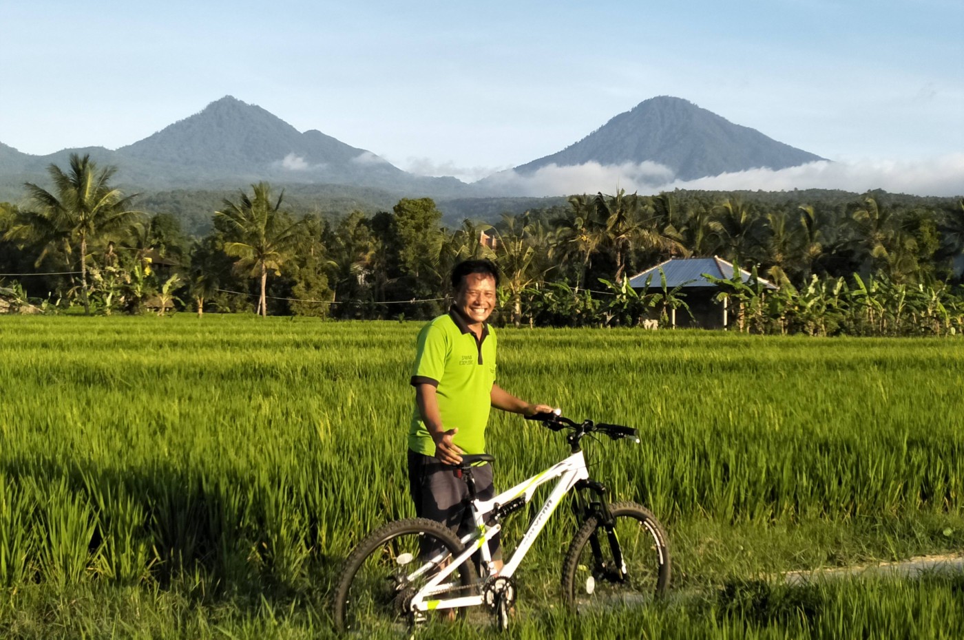 man with a bike in the rice fields at Sanak Retreat, Munduk, Bali, Indonesia
