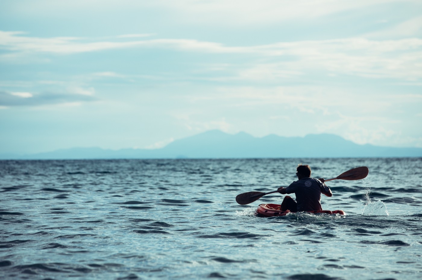 man kayaking at lake in front of Greystoke Mahale, Tanzania
