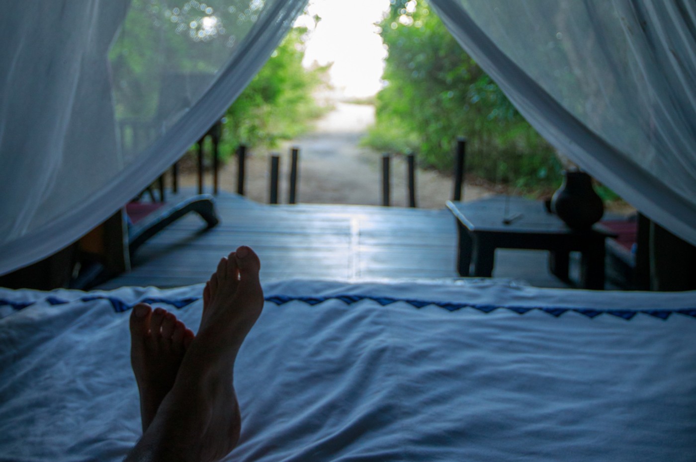 Feet in bed and view over the lake at Greystoke Mahale, Tanzania