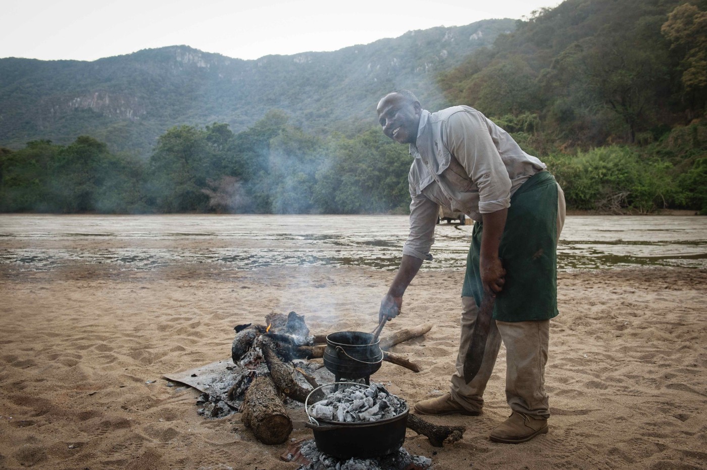 chef cooking food over fire at Wayo Manyara Green Camp, Tanzania
