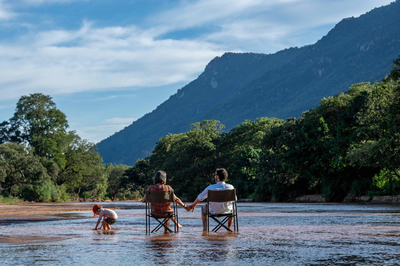People sitting in the river at Wayo Manyara Green Camp, Tanzania