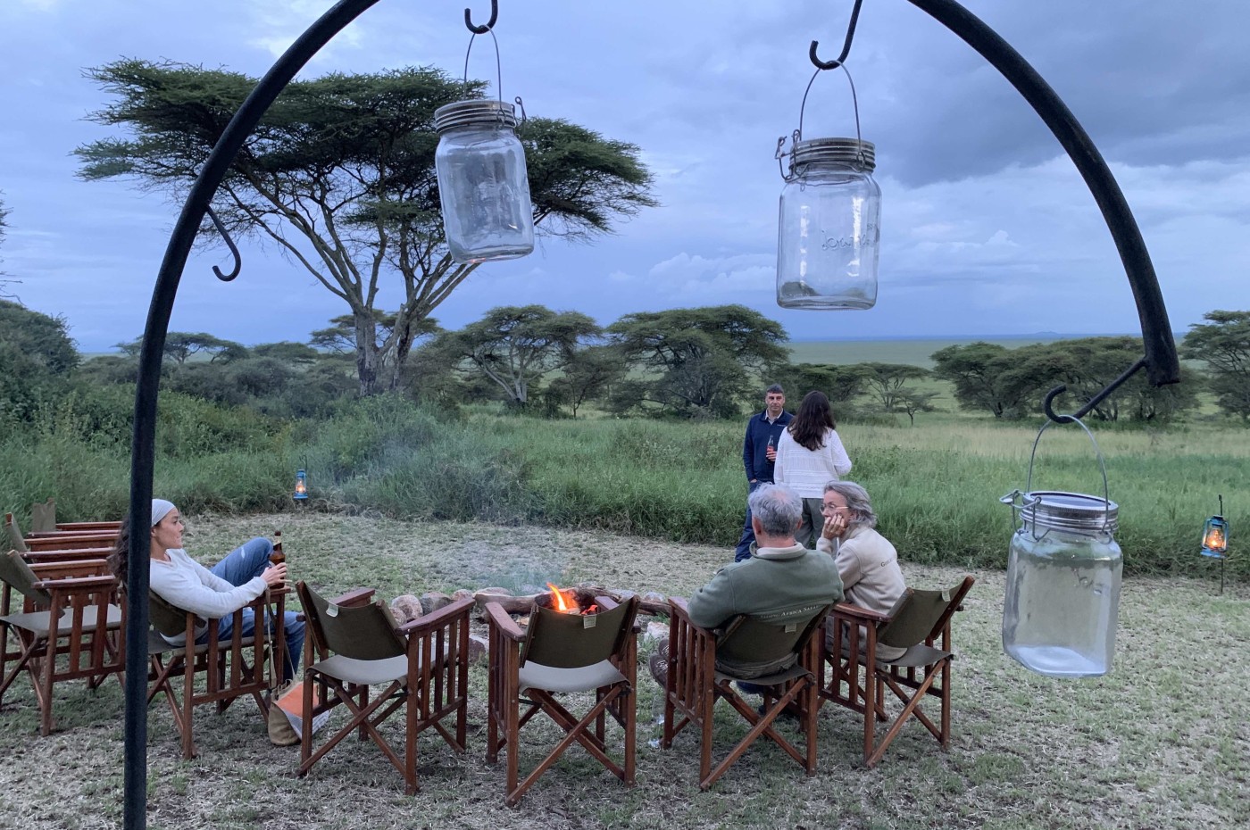 people wathing bonfire at Wayo Serengeti Green Camp, Tanzania