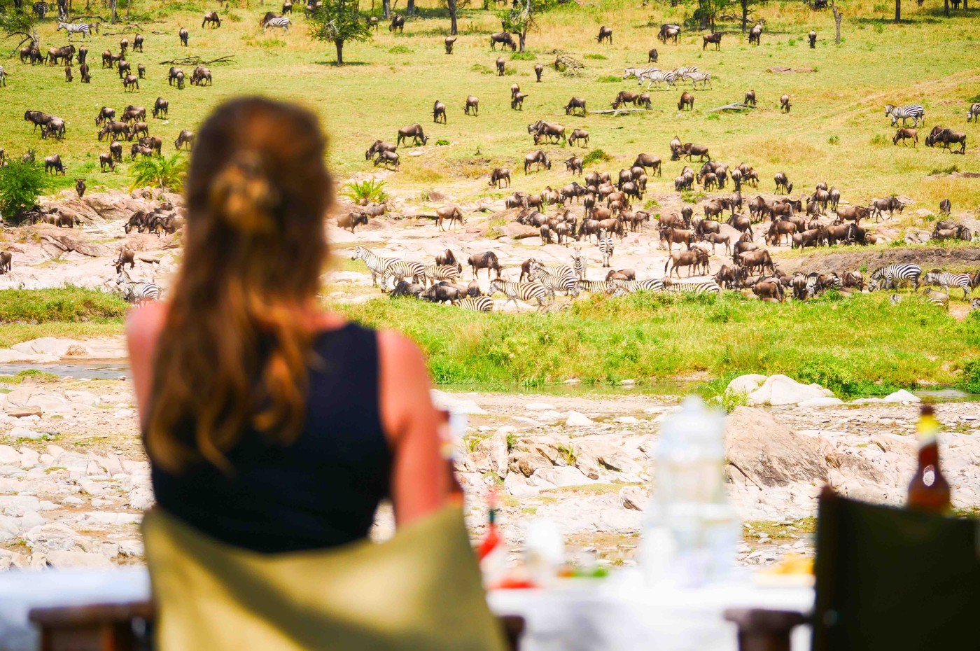 Woman looking at the wildlife at Wayo Serengeti Green Camp, Tanzania