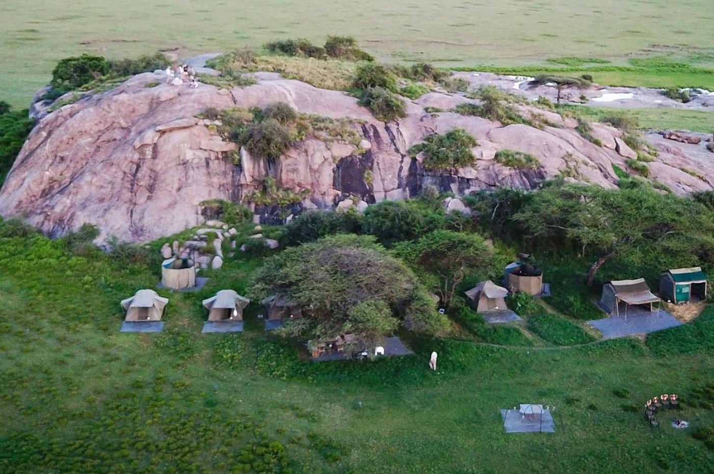 tents in front of the cliff on the savannah at Wayo Walking Safari Camp, Serengeti, Tanzania