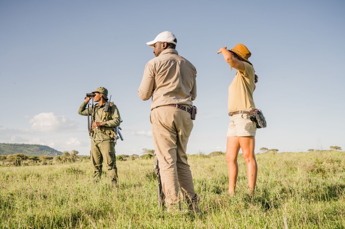 People looking over the savannah at Wayo Walking Safari Camp, Serengeti, Tanzania