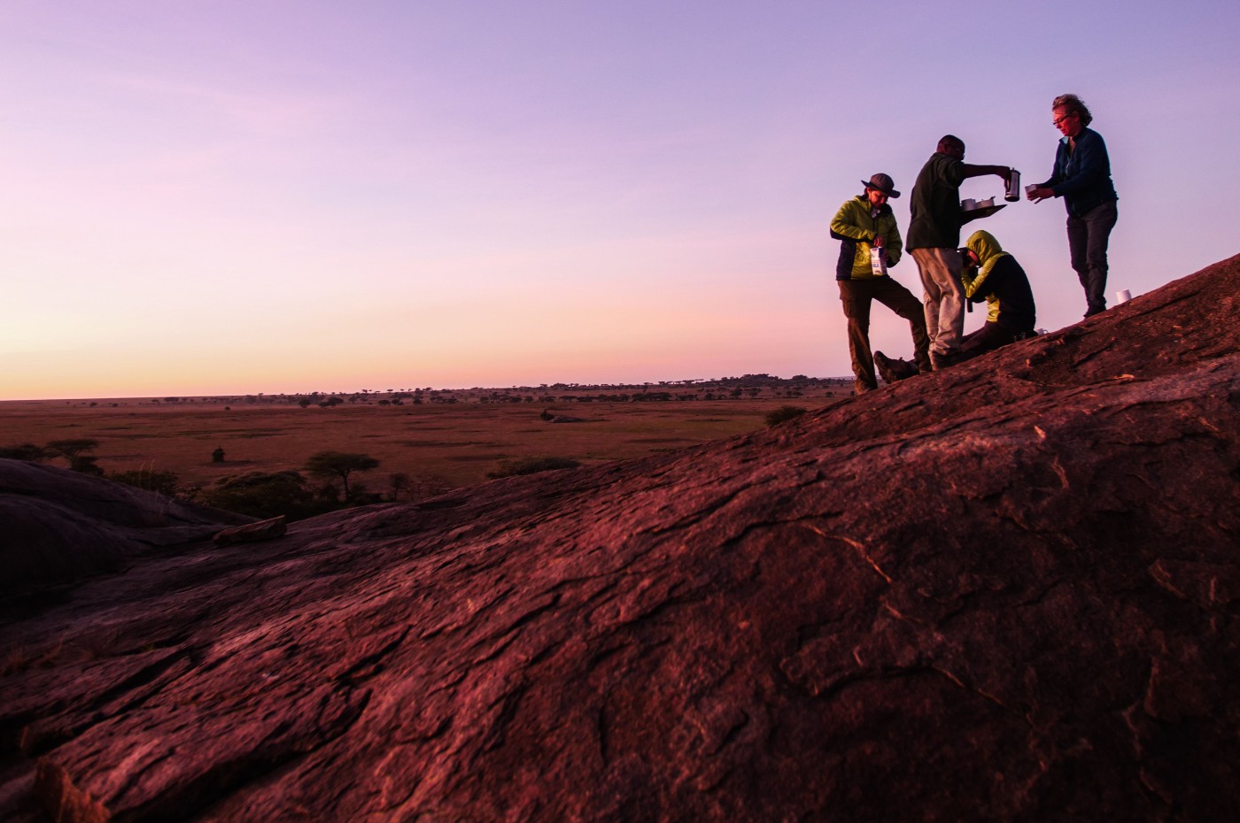 People waiting in the sunset at Wayo Walking Safari Camp, Serengeti, Tanzania