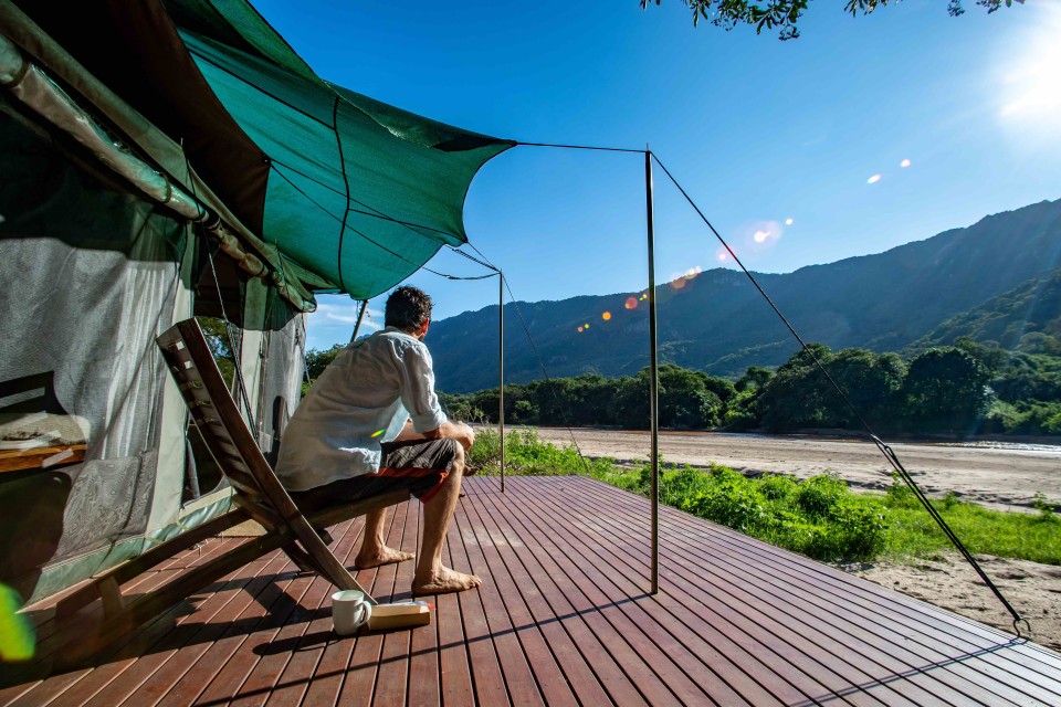 Man looking over the bush at Wayo Manyara Green Camp, Tanzania